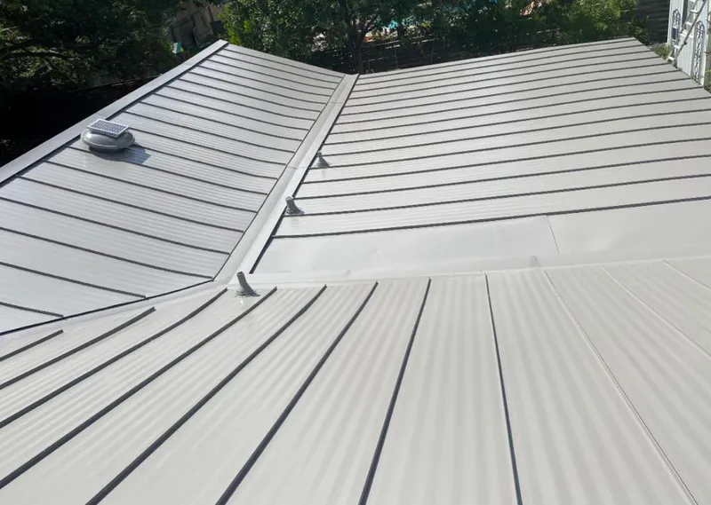 Solar attic fan installed on a metal roof for Roof Ventilation in North Elba